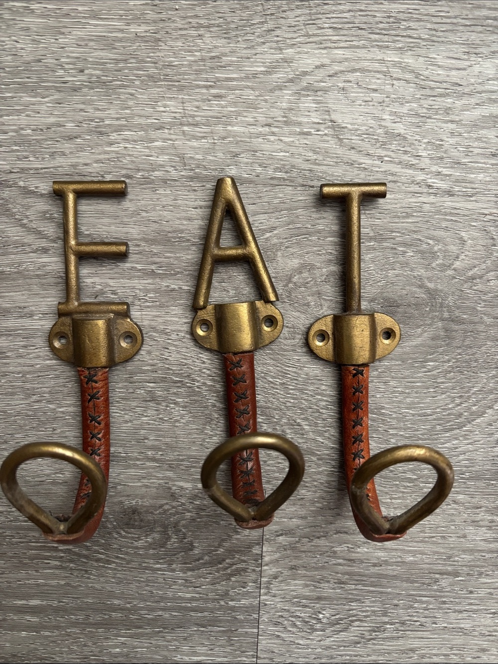 Anthropologie Gold 'EAT' Wall Hooks with Brown Leather Straps
